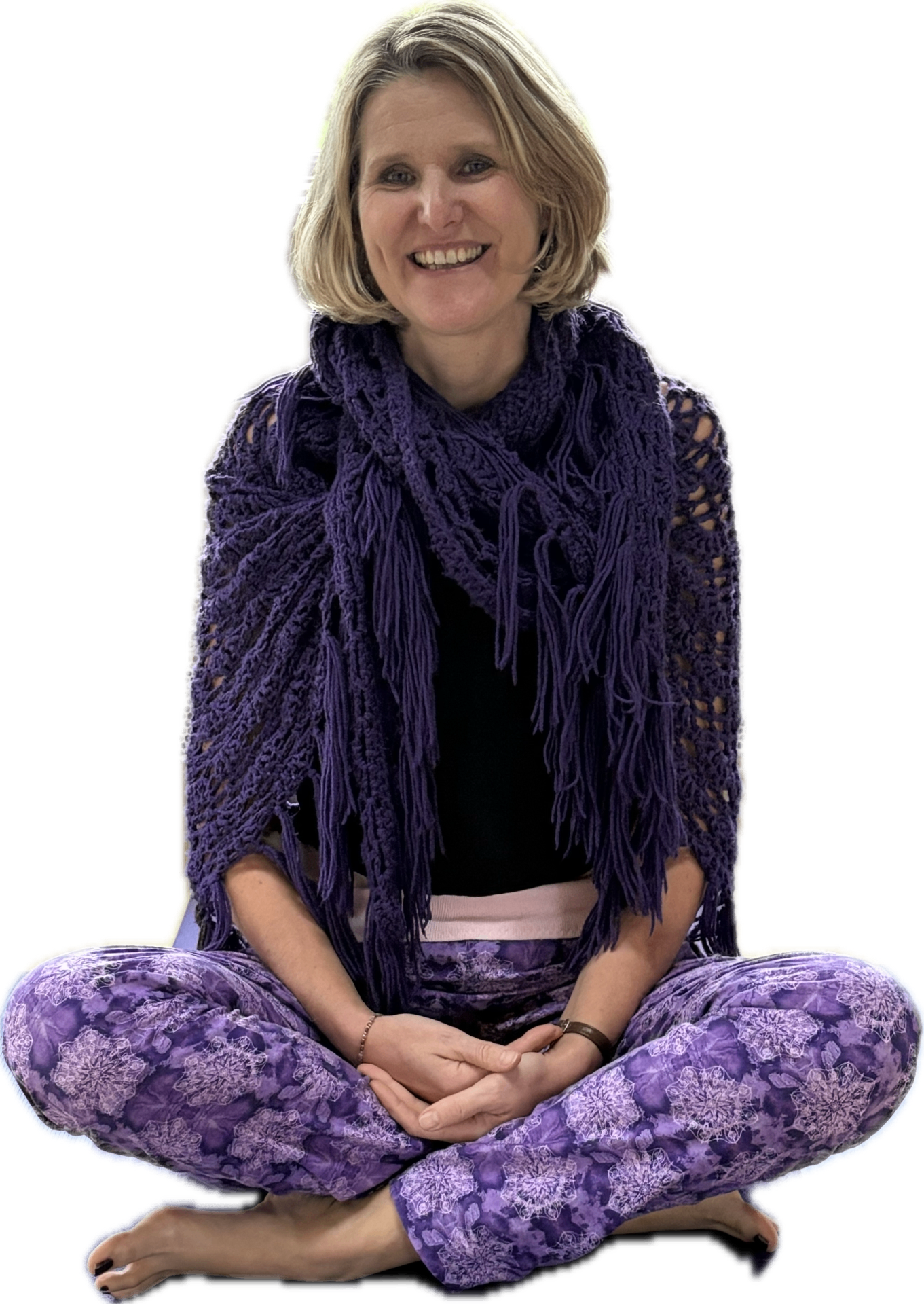 Katy, gentle Hatha yoga teacher, sitting cross-legged